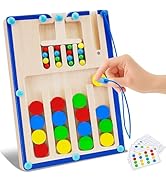 Wooden cylinder toy with colorful shapes. Contains rainbow-colored sticks, circles, and stars. Lid has slots for shape sorting. Hand demonstrating use with purple piece.