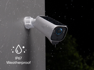 White outdoor security camera with IP67 weatherproof rating icon, shown against dark background with trees.