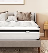 White mattress with orange accent border shown in bedroom setting against white wall, displaying layered construction with multiple comfort levels.