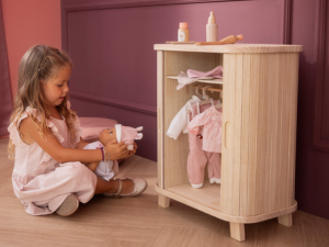 Wooden step or platform shown in different angles against a pink-toned background, demonstrating its construction and design features.
