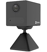 White EZVIZ indoor security camera with circular design, black lens, and small indicator light. Camera mounted on a thin white stand for tabletop placement.