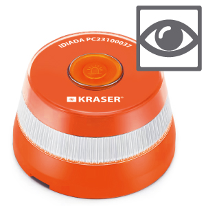 Hand placing red and yellow circular device onto car dashboard or windshield area, showing installation process.