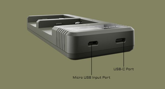 Close-up of a dark gray electronic device or holder with four illuminated blue indicator lights or icons visible on the surface.