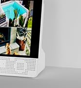 Close-up view of what appears to be a white electronic device or holder mounted on a wall or surface.