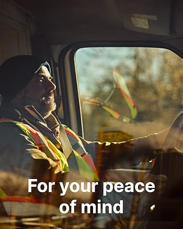 Interior view of a vehicle, showing side window and dashboard. Visible text 'For your peace of mind' overlaid on image. Reflective safety vest visible.