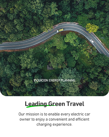 Modern glass office building exterior with electric vehicle charging station branding, featuring reflective windows and contemporary architectural design.