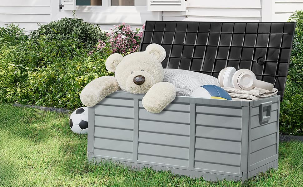 Outdoor storage box shown in multiple scenes - empty, filled with cushions and sports equipment, and in garden setting. Gray wooden slatted design with weathered finish.