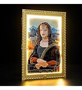 Toy figure resembling a house elf character, built from plastic bricks. Large green eyes, pointed ears, yellow robe. Holds a book. Beside it, a colorful illuminated cake-like structure.