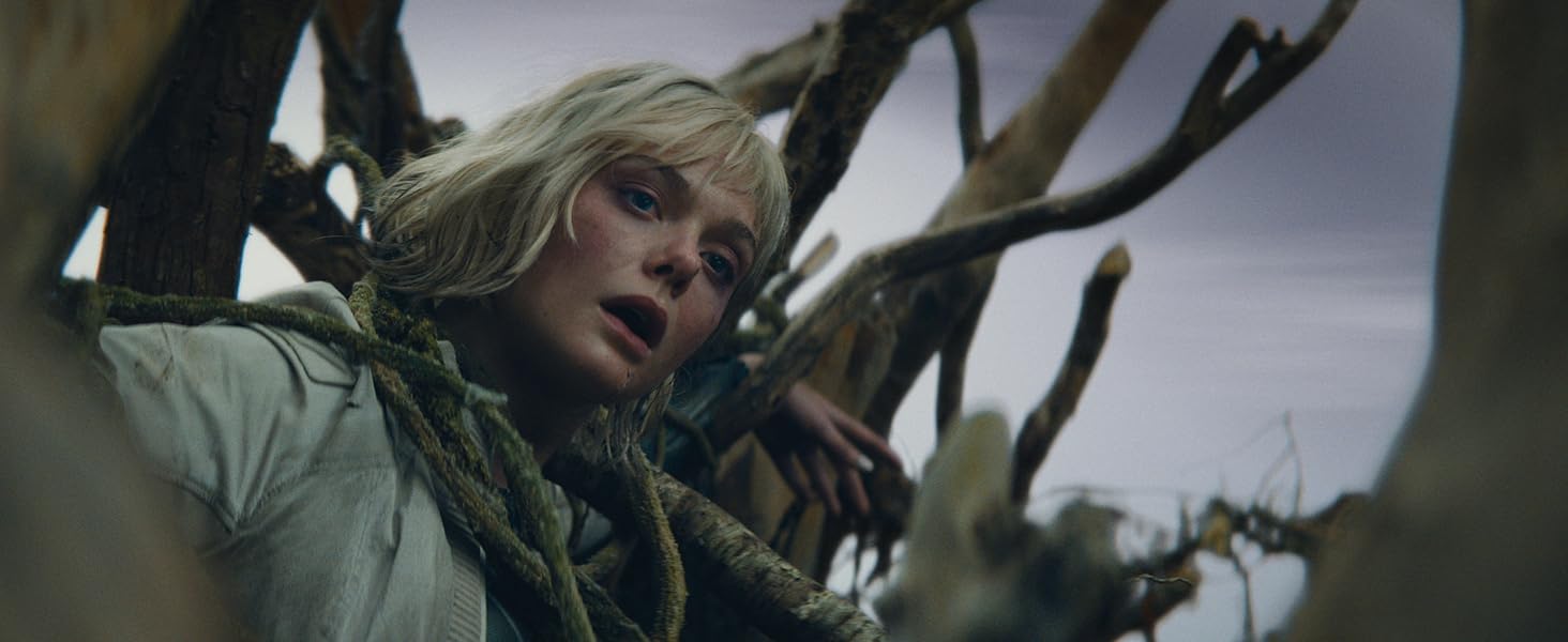 Silhouette of a figure standing in a cave opening against a bright sky, creating a dramatic backlit effect.