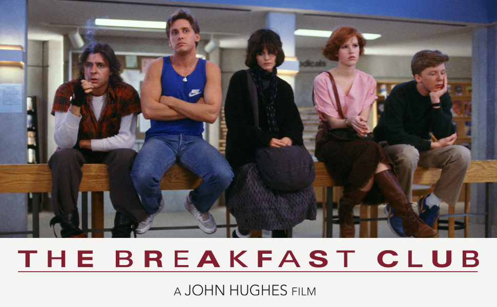 Text reads 'THE BREAKFAST CLUB' and 'A JOHN HUGHES FILM'. Group of people seated in what appears to be a library setting.