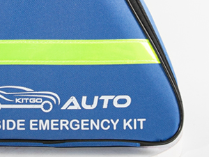 Text reads: 'MITO AUTO', 'SIDE EMERGENCY KIT'. Close-up of blue automotive emergency kit with high-visibility stripe.