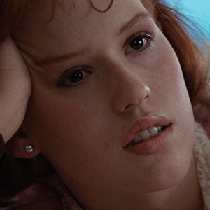 Scene in what appears to be a library or study setting with dark wood furnishings and subdued lighting.