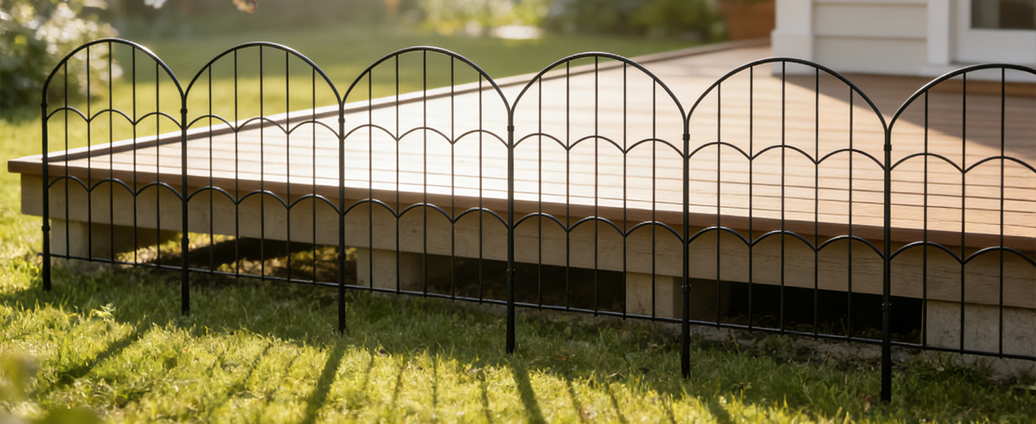 Ornate metal fence or gate photographed at sunset/sunrise, with sunlight streaming through the decorative iron bars creating dramatic shadows.
