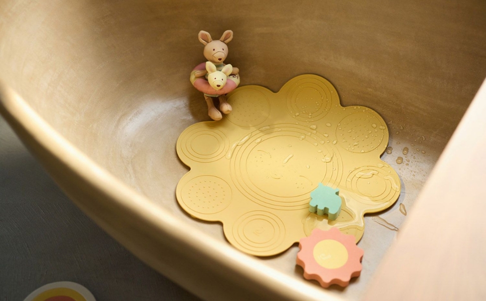 Wooden puzzle pieces with flower shapes being placed into corresponding slots in what appears to be a natural wood surface.