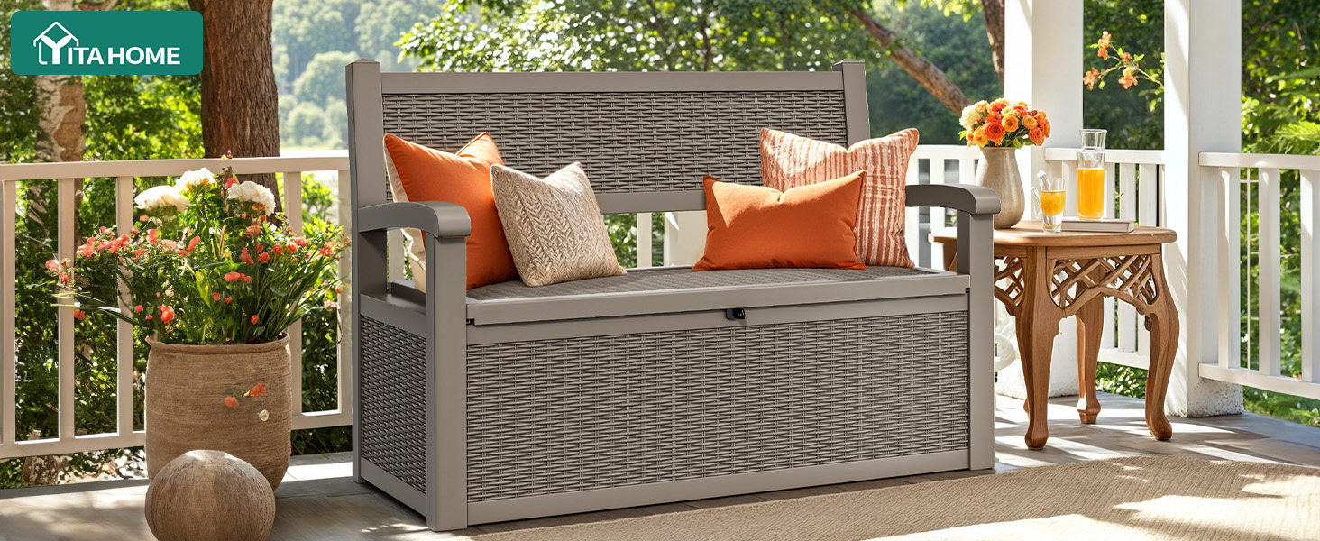 Outdoor patio furniture set featuring a gray woven sofa with orange accent cushions, shown in a sunny deck setting with decorative accessories.