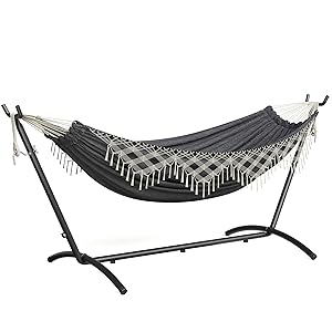 Multiple views of a black metal frame hammock shown in outdoor settings with sunlit grass background, demonstrating various usage positions.