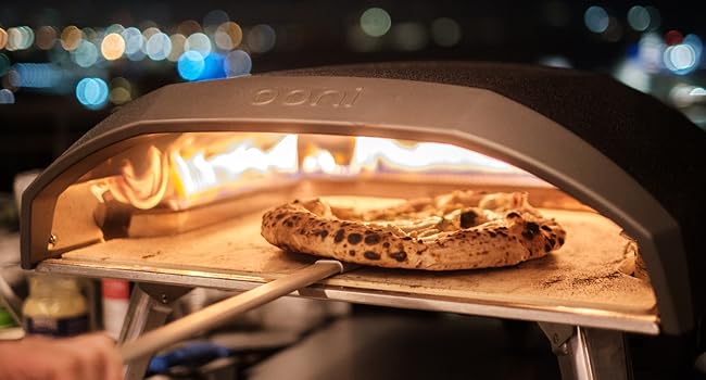 the pizza is cooked in a wood - fired oven.