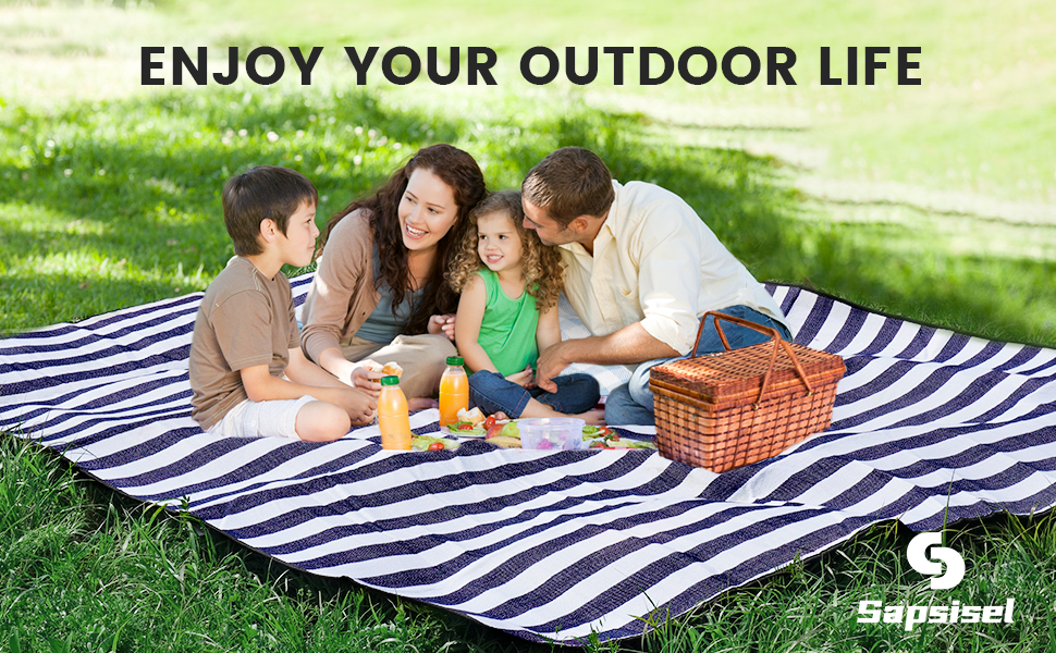 Text reads 'ENJOY YOUR OUTDOOR LIFE' and 'Euprssest'. Family of four on striped blue and white picnic blanket on grass with basket and beverages, outdoor recreation setting.