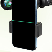 Black ball-mounted phone holder with adjustable grip arms and mounting bracket for dashboard or surface attachment.