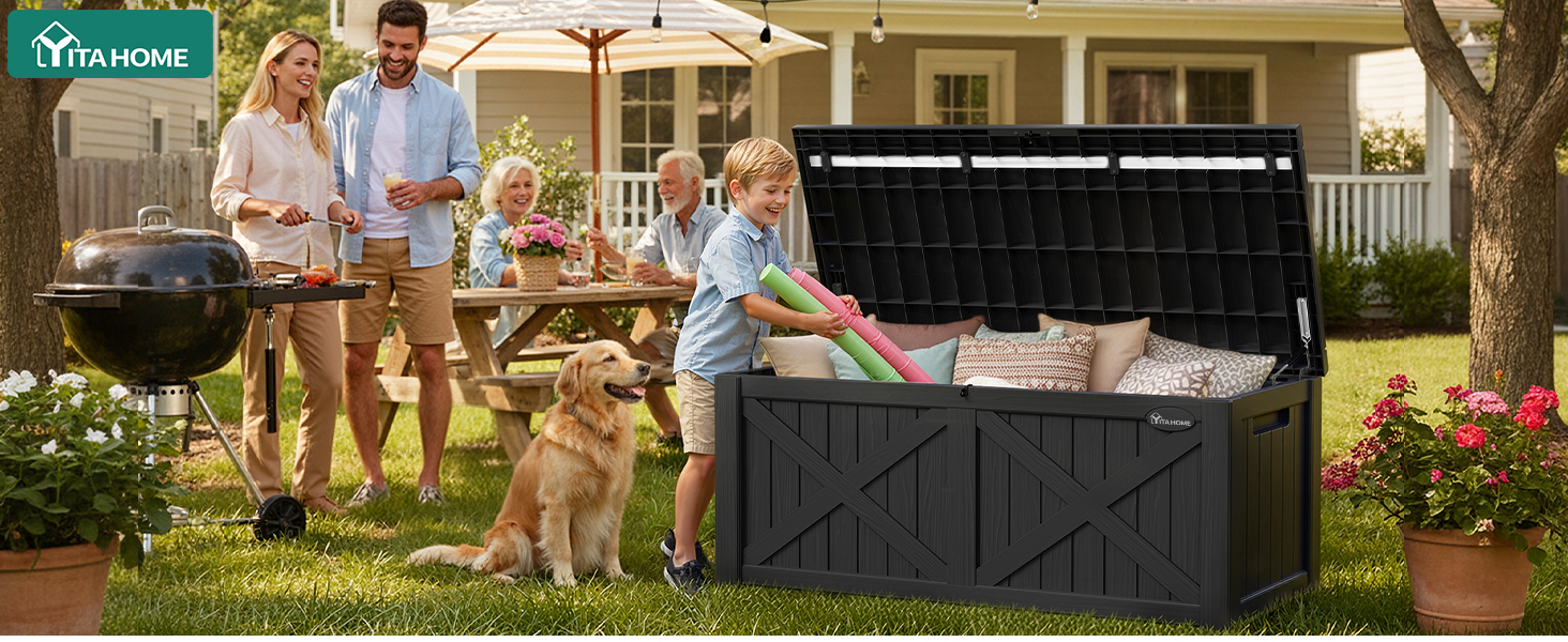 Family of four adults and children standing outdoors beside large black storage box/container on grass, suggesting portable storage solution for outdoor activities or household use.