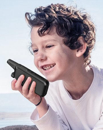 Professional two-way radio walkie-talkie being held and used in an industrial or construction setting, wearing protective work gloves.