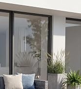 Text reads 'Image 2'. Modern minimalist interior featuring white cabinets and large windows, with natural light creating reflections on glass surfaces.