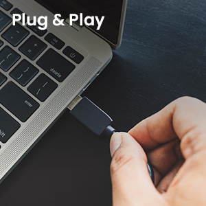Text reads 'Plug & Play'. Hand inserting USB connector into laptop port against dark background. Image demonstrates simple connection procedure for computer peripheral device installation.