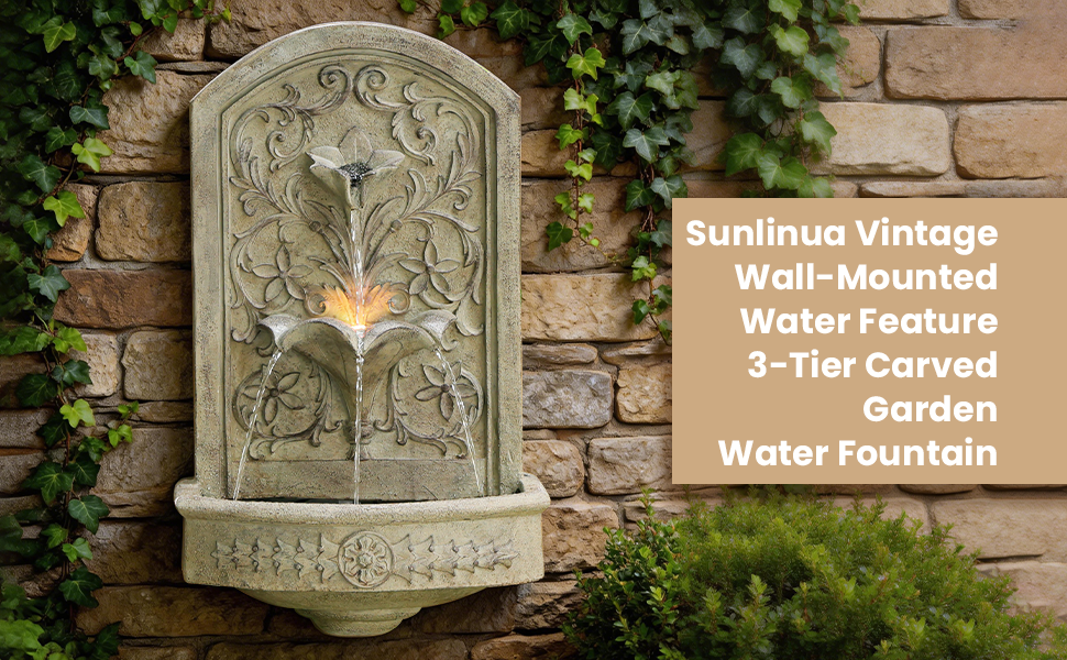 Text reads 'Sunnique Vintage Wall-Mounted Water Feature 3-Tier Carved Water Fountain'. Stone wall fountain with ornate carved design featuring bird motif, mounted on brick wall with ivy.