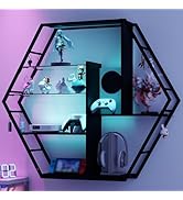 Gaming setup with purple LED lighting, featuring black wall-mounted shelving unit displaying gaming consoles, controllers, and accessories.
