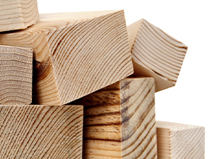 Stack of cut lumber pieces showing clean-sawn wooden planks with visible wood grain texture.