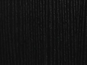 Close-up texture of black ribbed or corduroy fabric showing vertical striped pattern.
