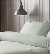 Text reads 'bed linen' 'Stylish and contemporary bed linen available in a range of colors and designs.' 'Soft, breathable fabrics ensure a luxurious feel and a great night's sleep.' White bedding displayed on bed.