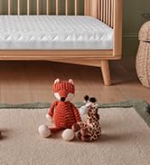 Wooden rainbow stacking toy with natural finish, featuring curved arches in earth tones arranged on a light surface.