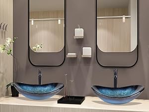 Modern bathroom interior with twin sinks, round mirrors, pendant lights, and towel rings. Features beige walls, blue vessel sinks, and black accents.