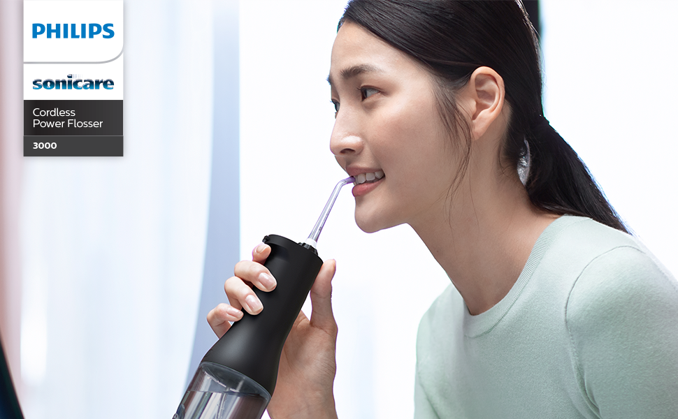 Text reads 'PHILIPS'. Product demonstration showing person using what appears to be a personal care device.
