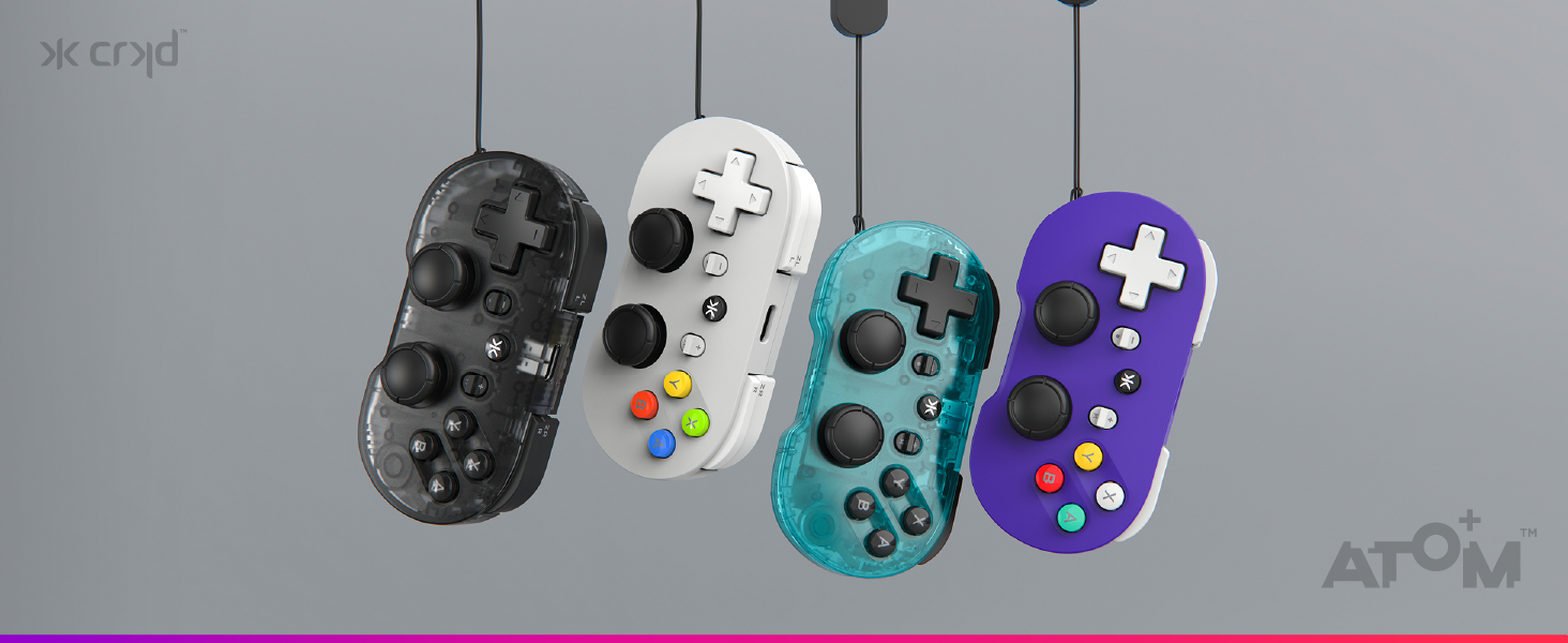 Four gaming controllers displayed in a row: black textured controller, white controller, turquoise/cyan controller, and purple controller with button layouts visible against gray background.