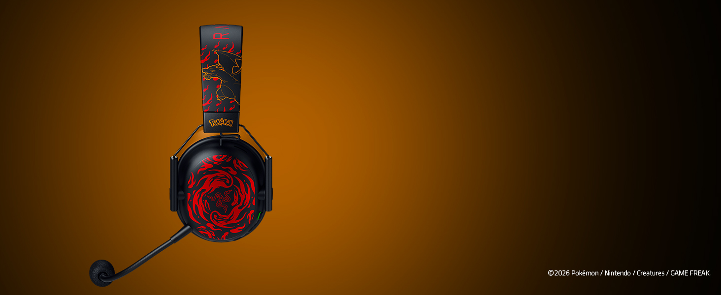 Black over-ear gaming headset with red accents photographed against warm golden-brown background. Device shown from side angle.