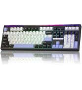 Mechanical keyboard with white keycaps, gray base layer, and RGB lighting across full-size layout. Black spacebar and accent keys with reflective surface display visible below.