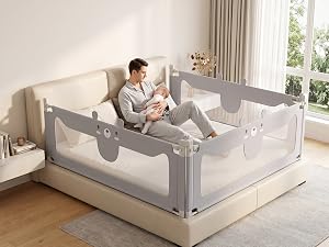 Gray mesh bed rail safety gate attached to standard bed frame with beige base. Adult demonstrates product while sitting on bed with child inside enclosed safety area. Includes storage pockets on sides.