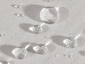 Close-up of hands holding and adjusting beige or tan-colored fabric cords or straps with a metal eyelet or grommet attached, demonstrating textile fastening or adjustment mechanism.